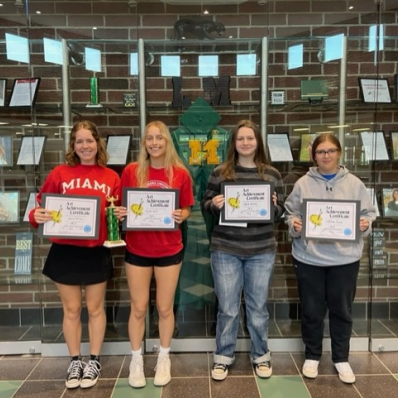 students smiling holding certificate